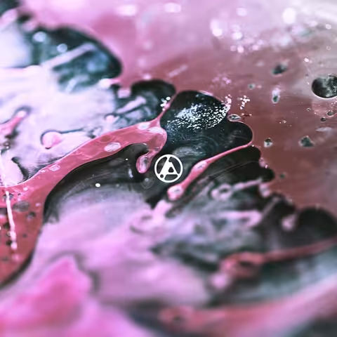 Cover of From Zero by Linkin Park: an abstract macro-photograph of swirling liquid by Brian Ziff, with the small Linkin Park hexagonal logo by Josh Foster positioned dead-centre.