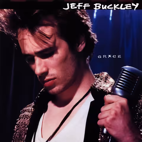Front cover of Grace: a photograph of Jeff Buckley looking downwards, gripping a vintage chrome microphone and wearing a sequinned jacket over a white vest, against a dark blue curtain, with his name in white across a black strip at the top and the title in small white letters beside his head.