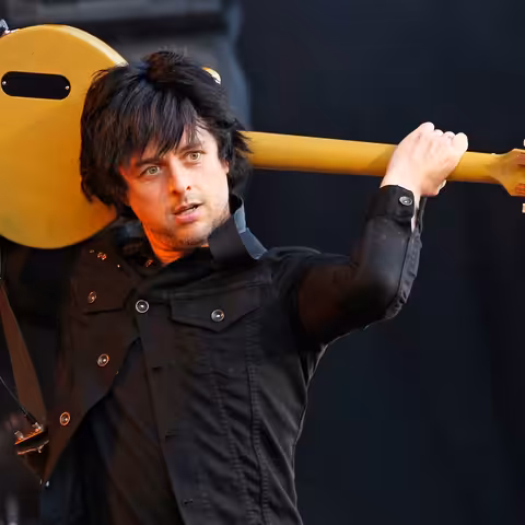 Billie Joe Armstrong of Green Day singing into a microphone on stage at Rock im Park in Germany in 2013.