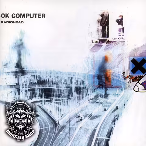 Front cover of Radiohead's OK Computer, a blue-and-white collage of a highway interchange with the band name in the top-left corner, designed by Thom Yorke and Stanley Donwood.