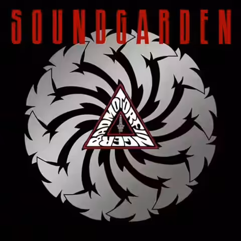 Cover of Badmotorfinger showing Mark Dancey's silver cyclone-like logo on black, the word Soundgarden in red above and a red triangle at the centre holding the album title and a spark plug.