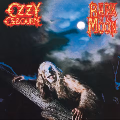 Front sleeve of Ozzy Osbourne's 1983 album Bark at the Moon, showing the singer crouched in a fog-bound churchyard wearing elaborate prosthetic werewolf makeup, fangs bared and clawed hand raised toward the camera.