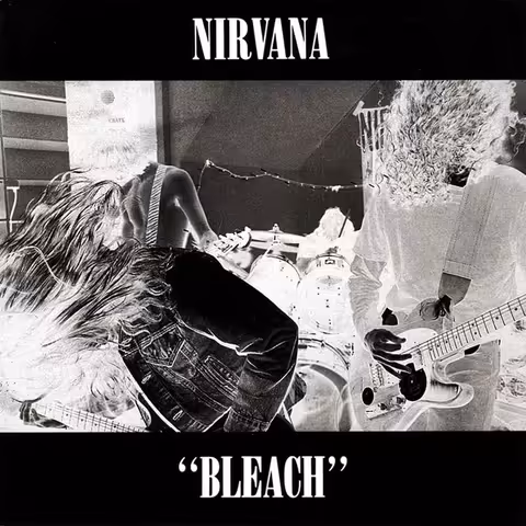 Front cover of Nirvana Bleach (Sub Pop, 1989), a high-contrast colour-reversed black-and-white live photograph by Tracy Marander showing the band on stage with the album title and band name set in plain serif type.