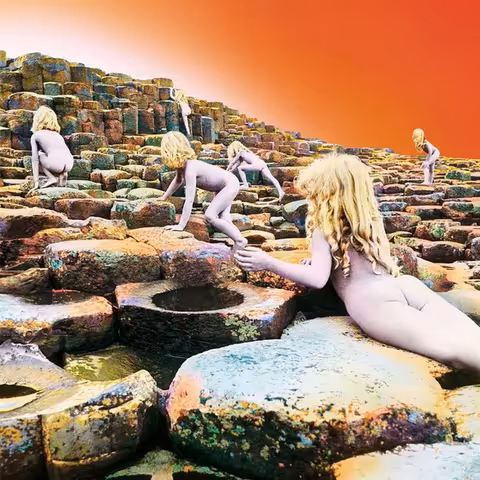Hipgnosis sleeve for Houses of the Holy: a collage of blonde, naked child figures climbing the basalt stairsteps of the Giant's Causeway under an orange and violet sky.
