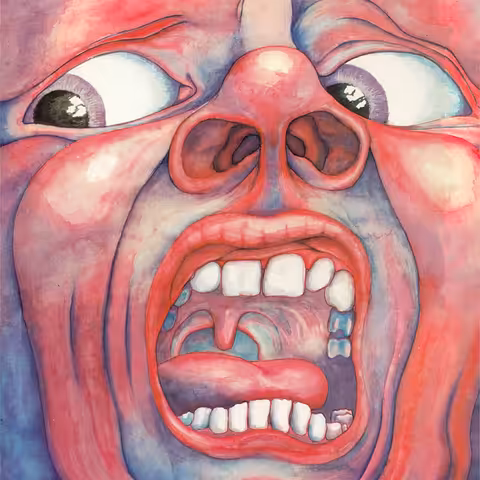 Front cover of In the Court of the Crimson King: Barry Godber's painting of a screaming face filling the entire sleeve, mouth stretched wide to show teeth, tongue and uvula, nostrils flared and bulging eyes glancing sideways, washed in reds, pinks and violet-blue, with no band name or title anywhere on it.