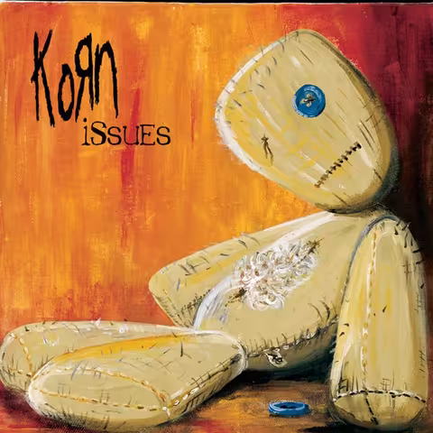 Alfredo Carlos's winning MTV fan-designed cover for Korn's Issues: a translucent, broken-faced doll-like figure rendered in muted blues and greys.