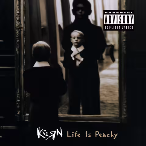 Front cover of Life Is Peachy by Korn, photographed in black and white by Martin Riedl, showing a small blond boy adjusting his tie in a gilt mirror while a tall shadowed figure looms behind him.