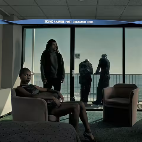 European edition cover art for Skunk Anansie's third album Post Orgasmic Chill, with the band photographed in a stylised oceanside apartment by Michael Nash Associates