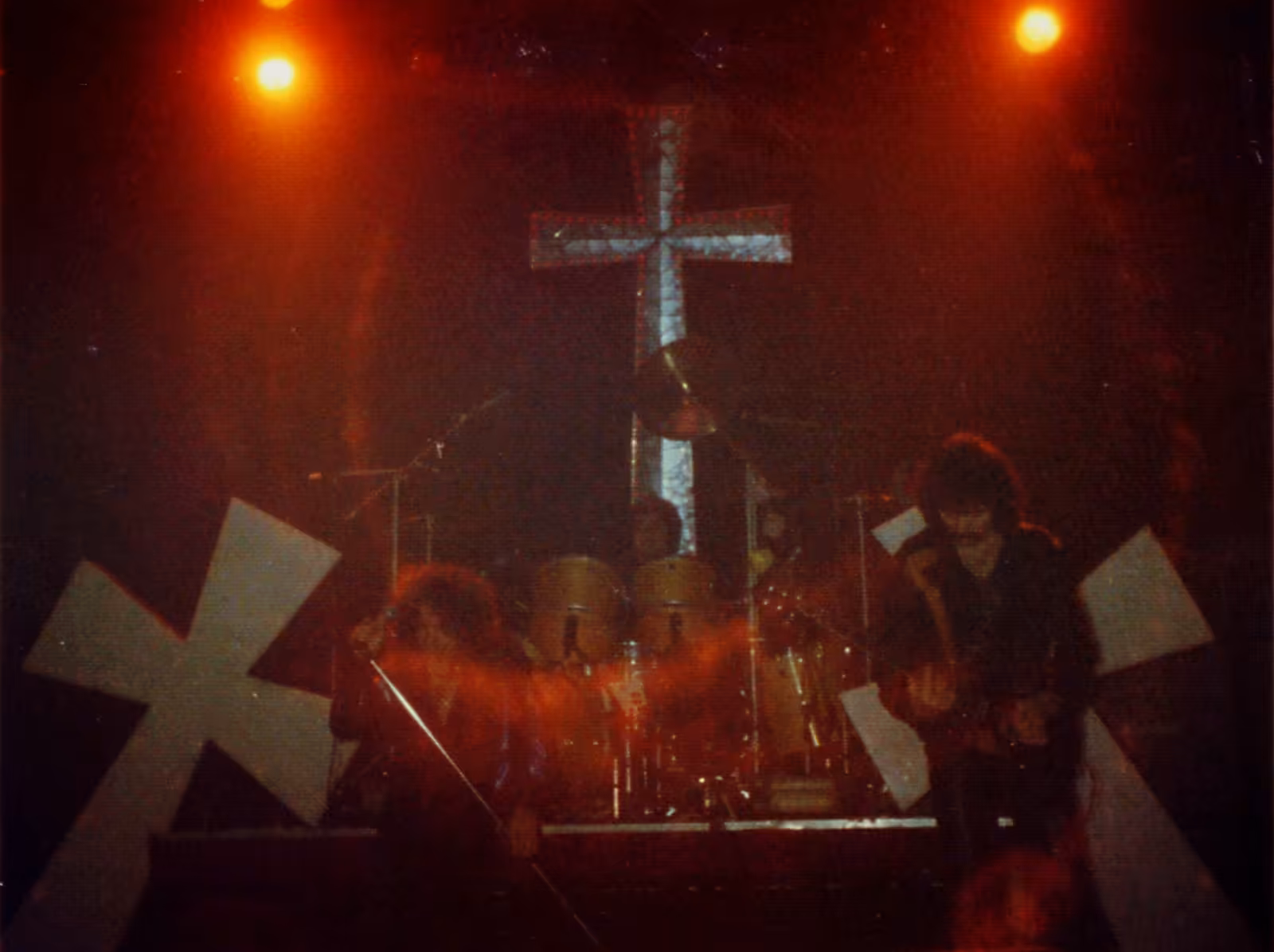 Black Sabbath performing live on a darkened stage in Cardiff in 1981.