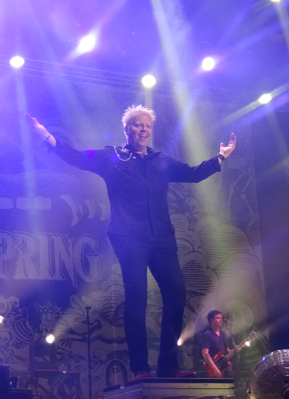 The Offspring frontman Dexter Holland singing and playing guitar live in Rome in 2017.